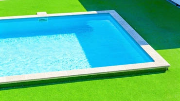 Professional base preparation for poolside turf installation in Dallas
